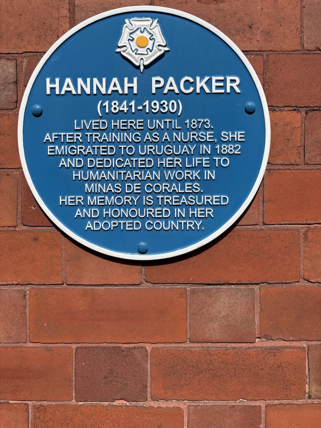 The blue plaque to Hannah Packer, nurse, on the red brick wall of the house she lived in until 1873