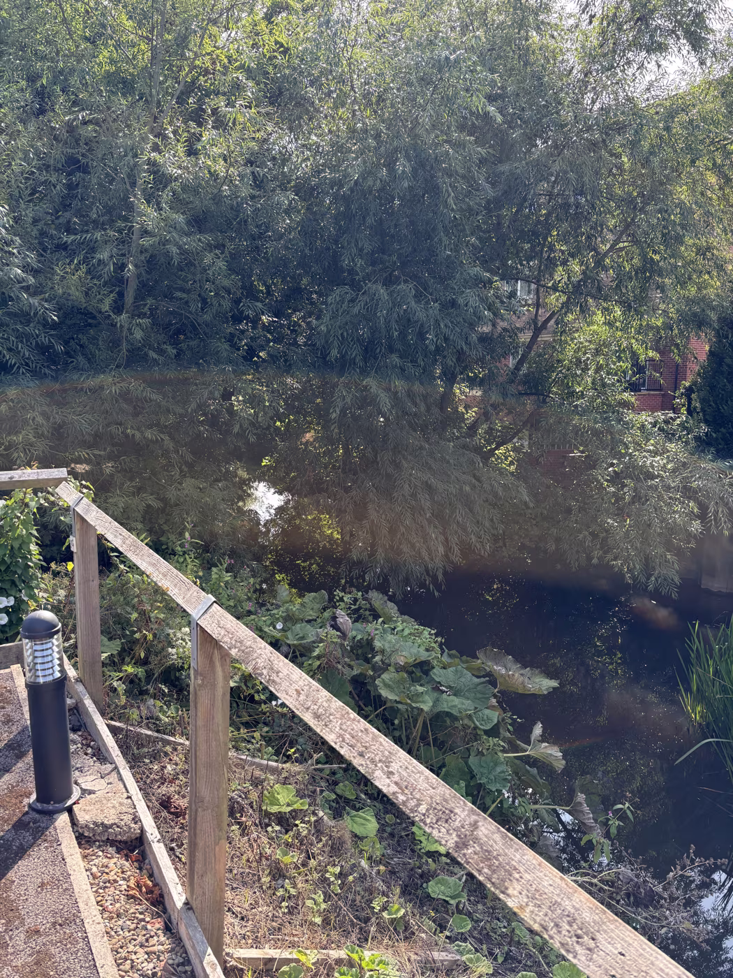The timber handrail alongside the beck near the town centre