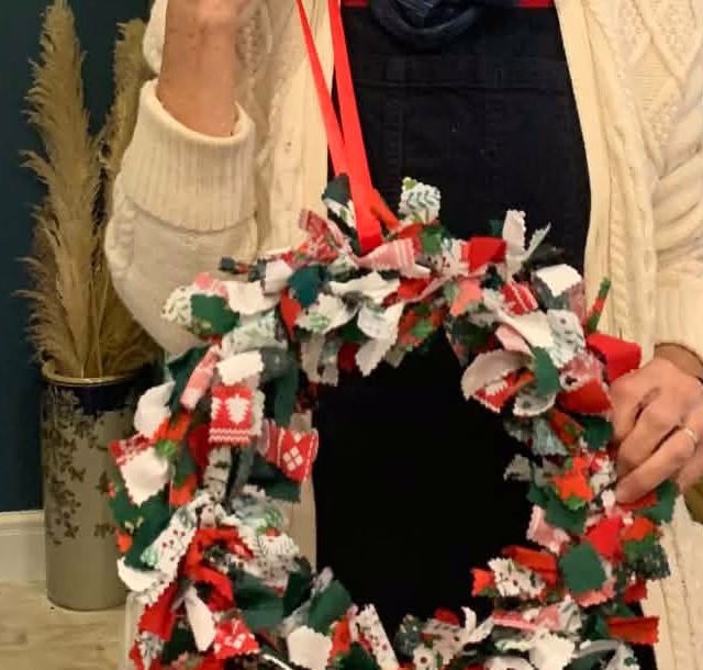 Close detail of reused fabric strips tied around Helen's Christmas wreath