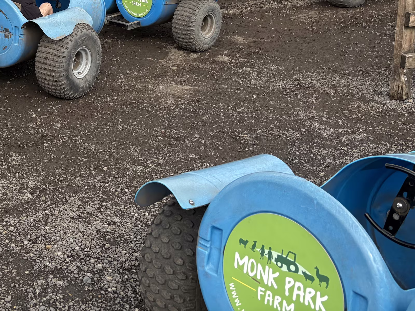 One of the barrel carts the tractor pulls round Monk Park Farm, blue with the farm logo on the end