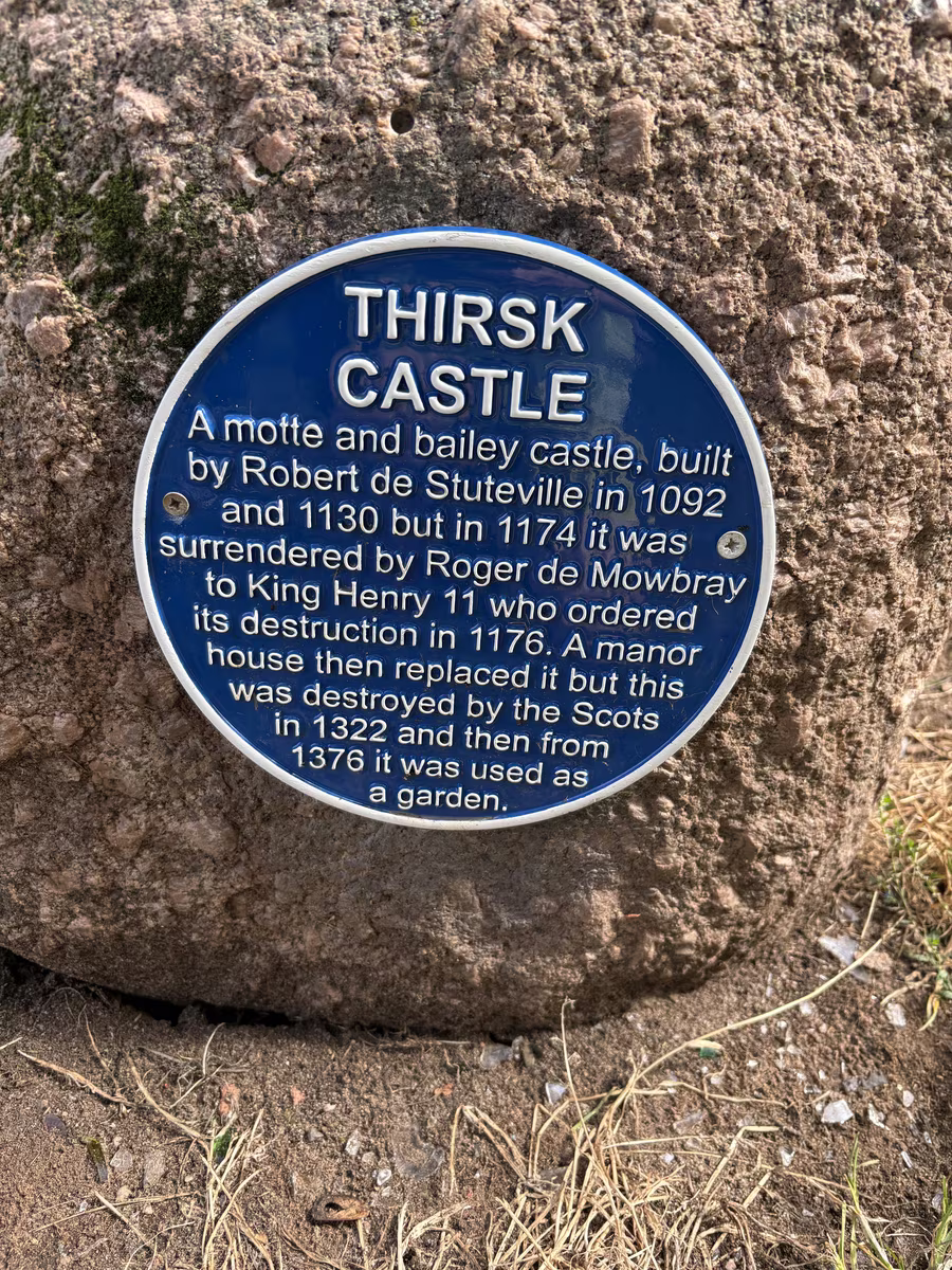 The blue plaque on its boulder, giving the castle story in six lines