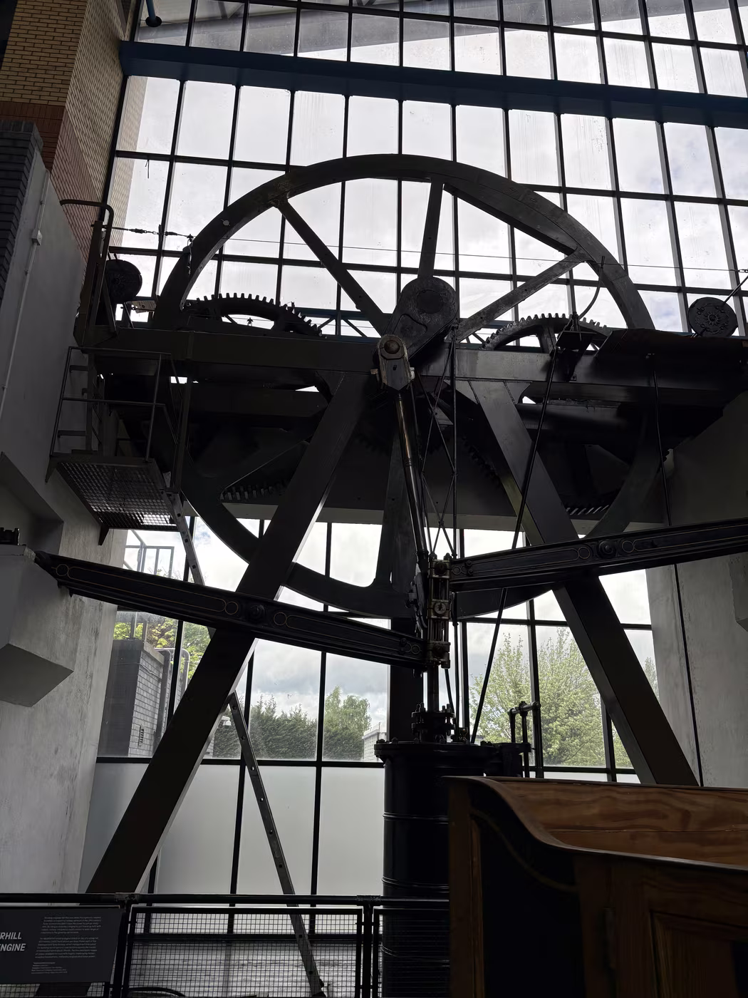 The winding engine standing against the museum's window wall